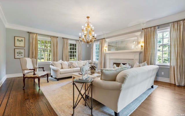 living room featuring a notable chandelier, wood-type flooring, and crown molding