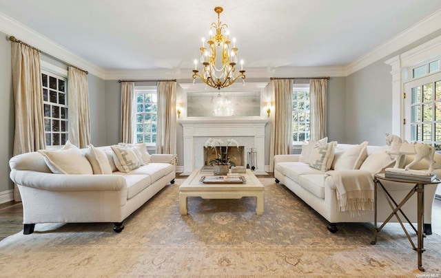 living room featuring a fireplace, hardwood / wood-style floors, crown molding, and a notable chandelier