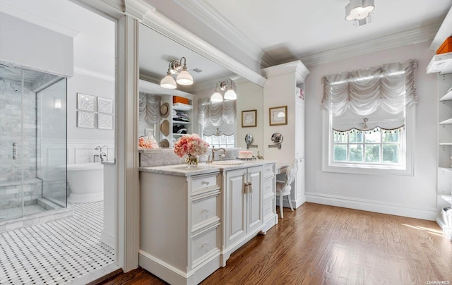 bathroom featuring wood-type flooring, vanity, shower with separate bathtub, and ornamental molding