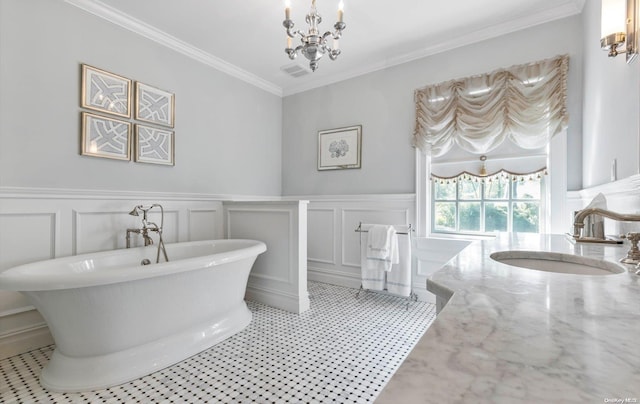 bathroom featuring a chandelier, vanity, crown molding, and a tub