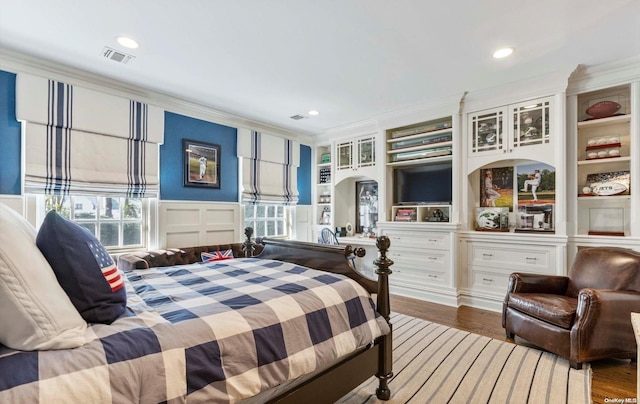 bedroom featuring wood-type flooring and crown molding