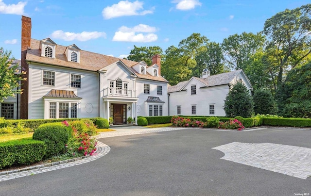 650 Chicken Valley Rd, Matinecock, NY 11560 - georgian-style home with a chimney and a balcony
