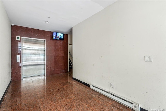 unfurnished room featuring a baseboard radiator