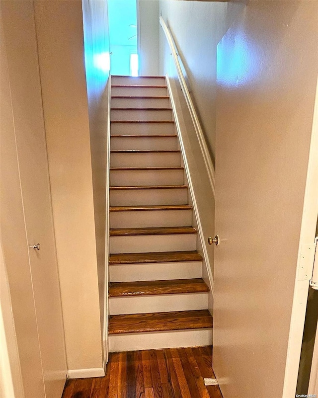 stairs featuring hardwood / wood-style floors