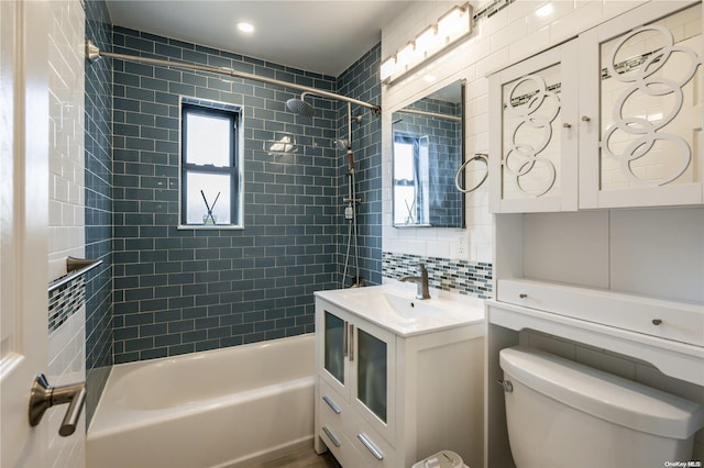 full bathroom featuring vanity, toilet, decorative backsplash, and tiled shower / bath