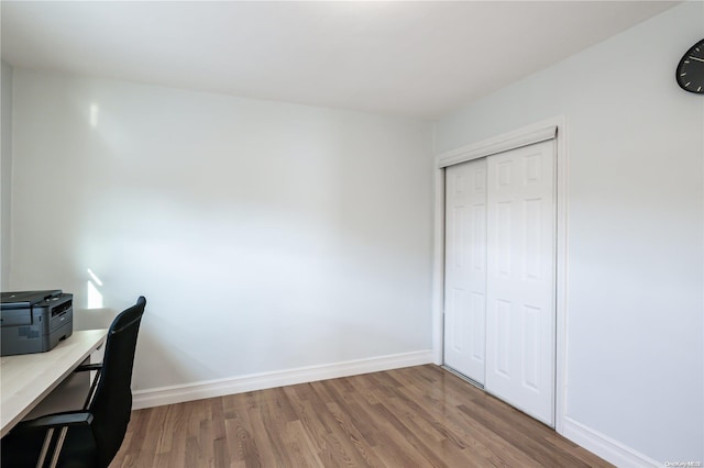 unfurnished office featuring hardwood / wood-style floors