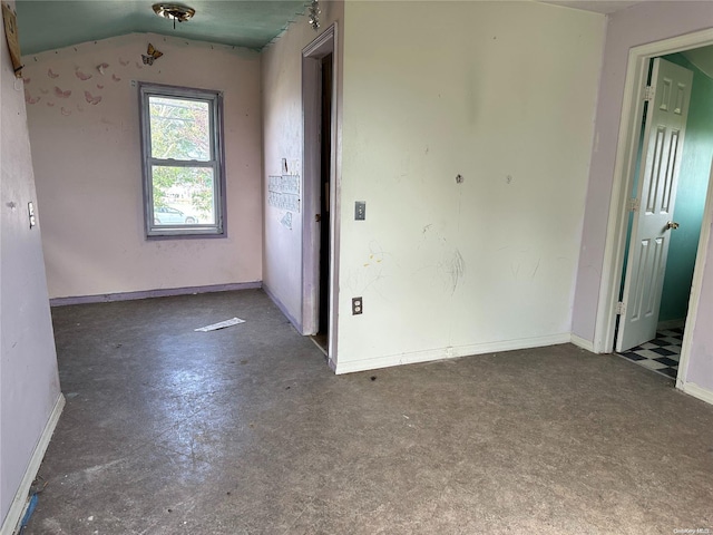 spare room featuring vaulted ceiling