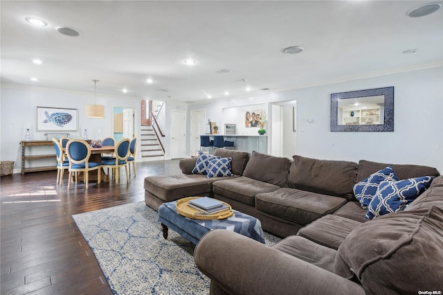 living room with ornamental molding and dark wood-type flooring