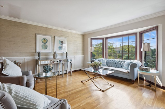 living room featuring hardwood / wood-style floors, baseboard heating, and crown molding