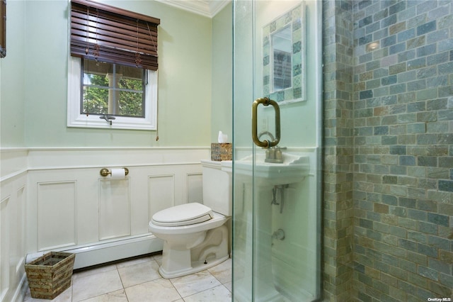 bathroom with a shower with door, tile patterned floors, crown molding, toilet, and a baseboard radiator