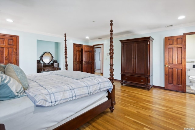 bedroom with ensuite bath, crown molding, and light wood-type flooring