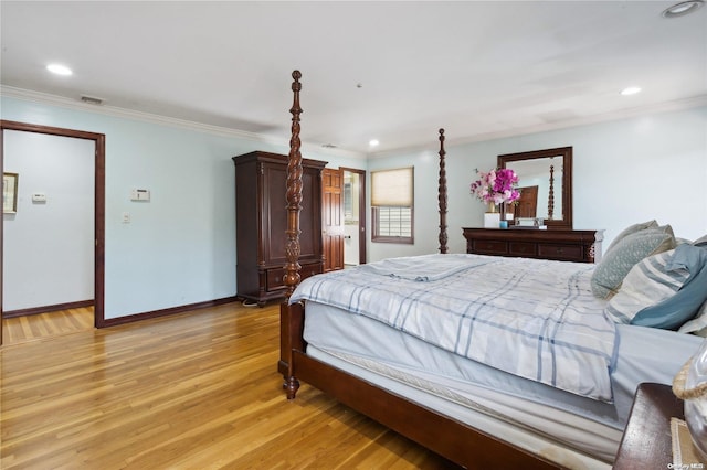 bedroom with crown molding and light hardwood / wood-style flooring