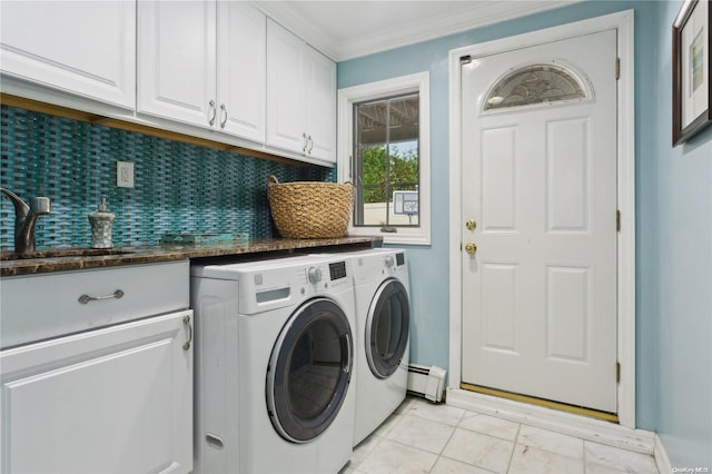 clothes washing area with sink, cabinets, baseboard heating, washer and dryer, and ornamental molding