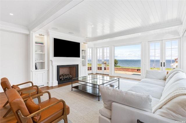 living room with french doors, hardwood / wood-style flooring, built in shelves, ornamental molding, and beamed ceiling