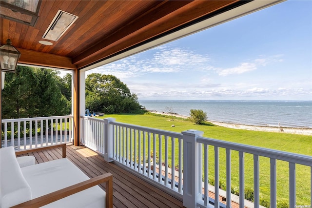 deck featuring a view of the beach and a water view