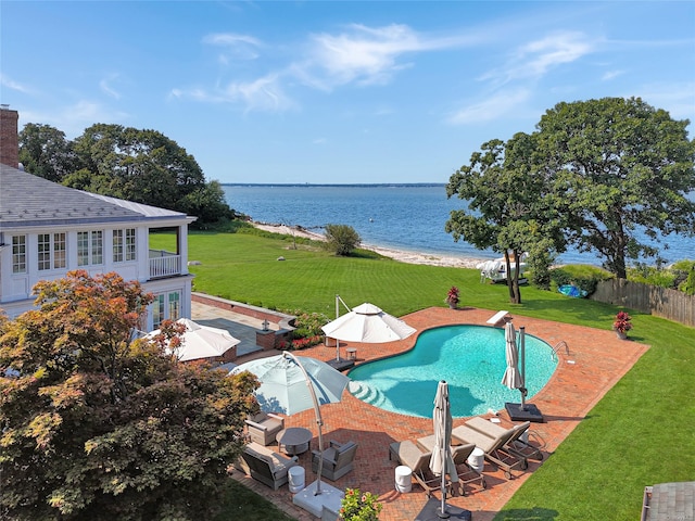 view of pool with a lawn, a diving board, a water view, and a patio