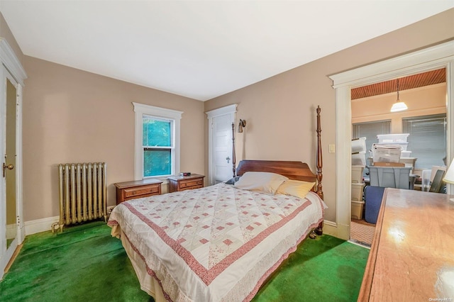 carpeted bedroom featuring radiator