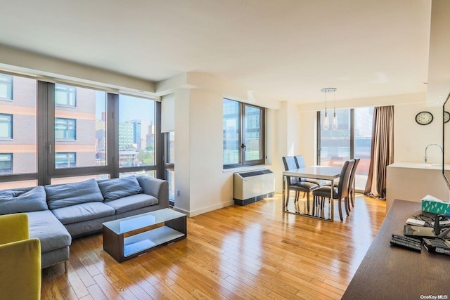 living room with light hardwood / wood-style floors and radiator