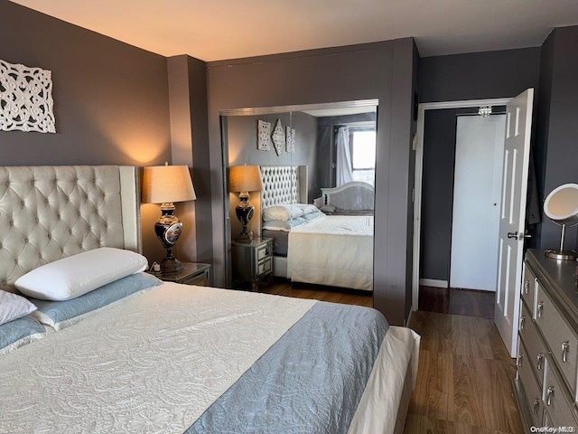 bedroom with dark hardwood / wood-style floors and a closet