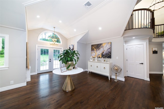 foyer entrance with dark hardwood / wood-style floors, crown molding, high vaulted ceiling, and french doors