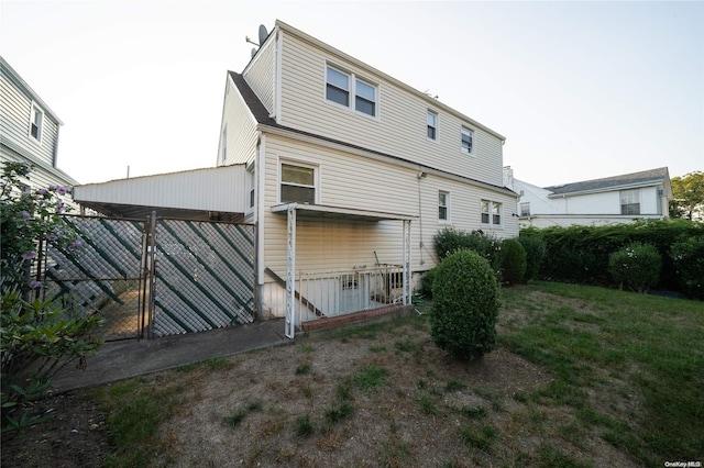 rear view of property featuring a yard