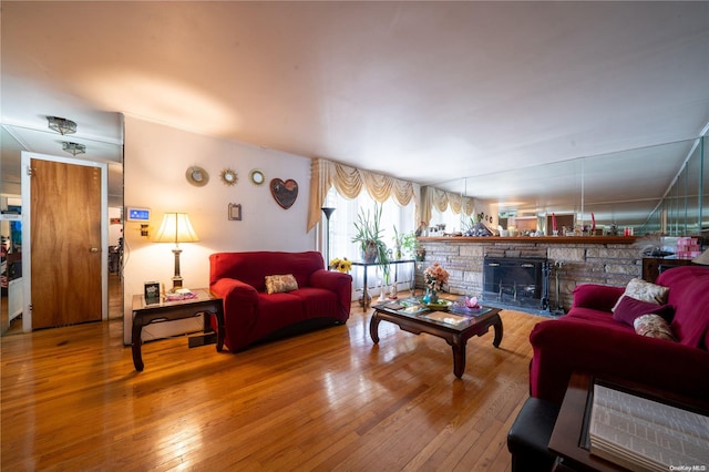 living room featuring a wood stove and hardwood / wood-style floors