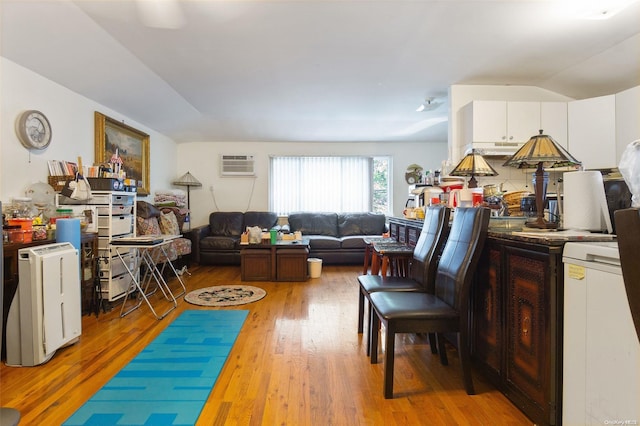 living room with hardwood / wood-style flooring and a wall mounted air conditioner