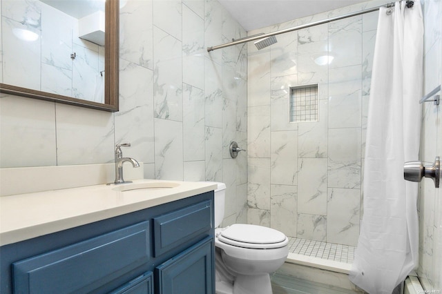 bathroom with curtained shower, tile walls, toilet, and vanity