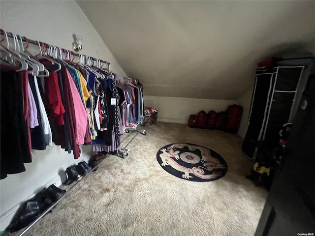 walk in closet featuring carpet flooring and vaulted ceiling