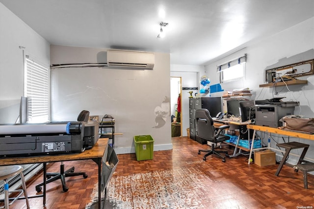 office space featuring parquet floors, a wall unit AC, and a wealth of natural light