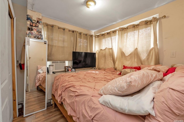 bedroom with hardwood / wood-style flooring and a closet