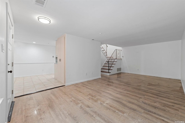 empty room with light hardwood / wood-style flooring