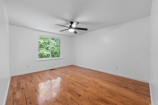 unfurnished room featuring hardwood / wood-style flooring and ceiling fan