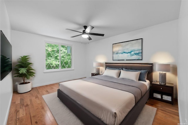 bedroom with ceiling fan and light wood-type flooring