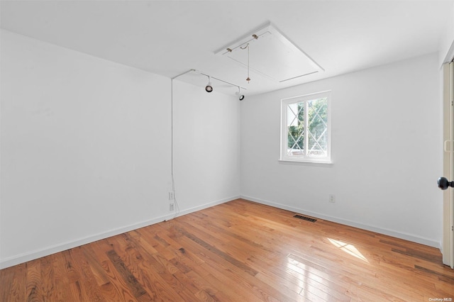 empty room featuring hardwood / wood-style flooring