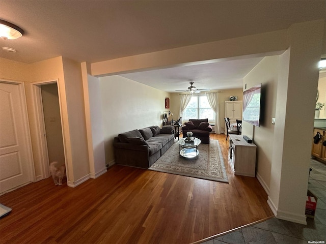 living room with dark hardwood / wood-style floors and ceiling fan