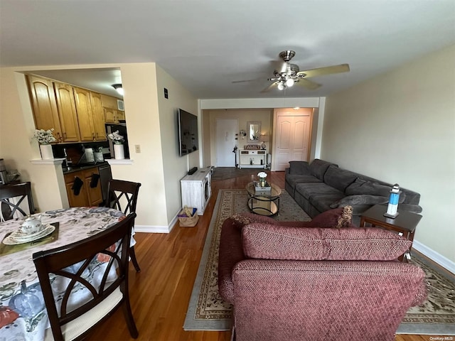 living room featuring ceiling fan and wood-type flooring