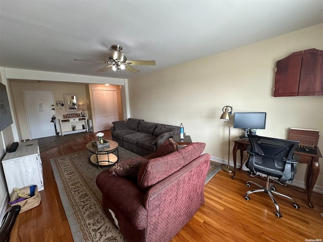 living room with hardwood / wood-style flooring and ceiling fan