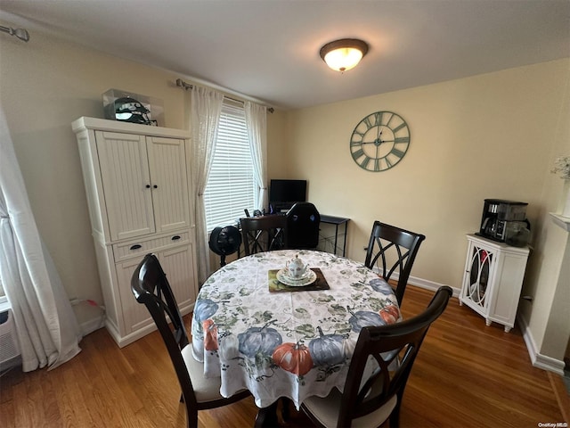 dining area with dark hardwood / wood-style flooring