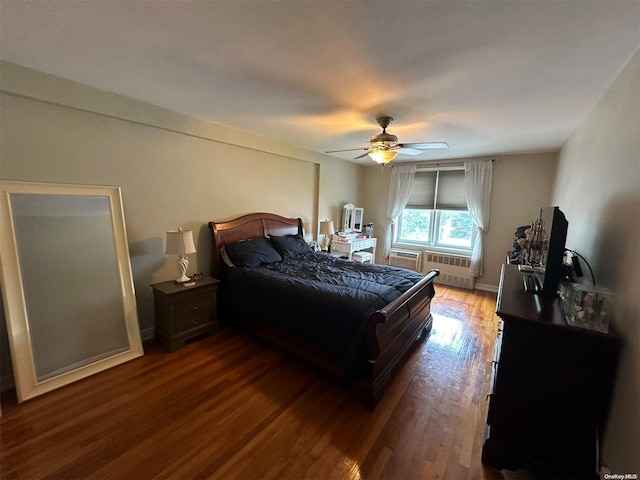 bedroom featuring radiator heating unit, dark hardwood / wood-style floors, and ceiling fan