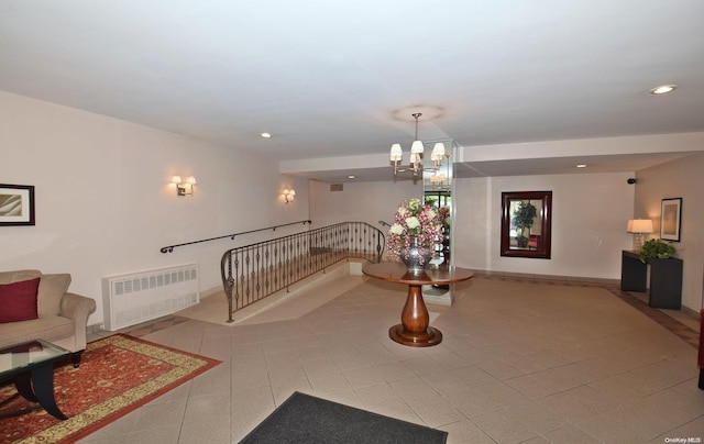 interior space featuring radiator, tile patterned flooring, and a notable chandelier