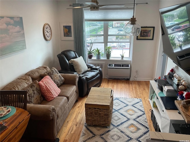 living room featuring ceiling fan and light hardwood / wood-style flooring