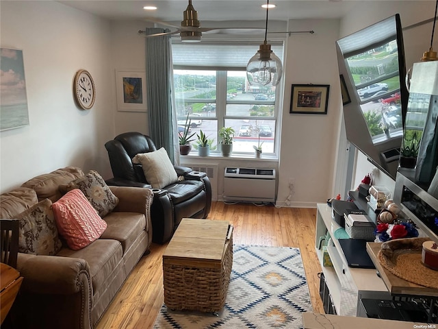 living room featuring ceiling fan and light hardwood / wood-style floors