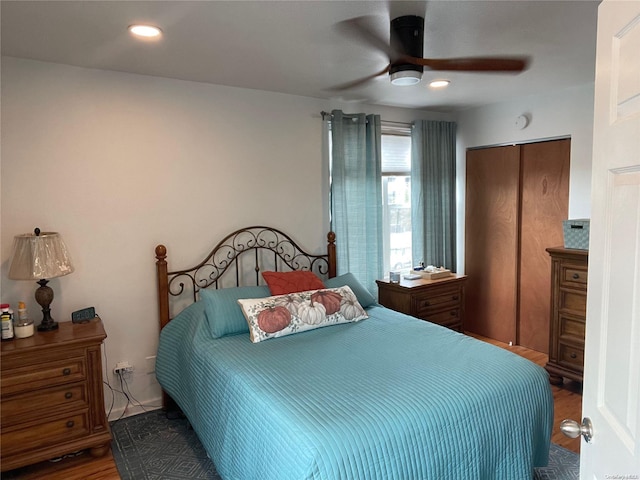 bedroom with a closet, ceiling fan, and hardwood / wood-style floors