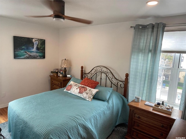 bedroom with hardwood / wood-style floors and ceiling fan