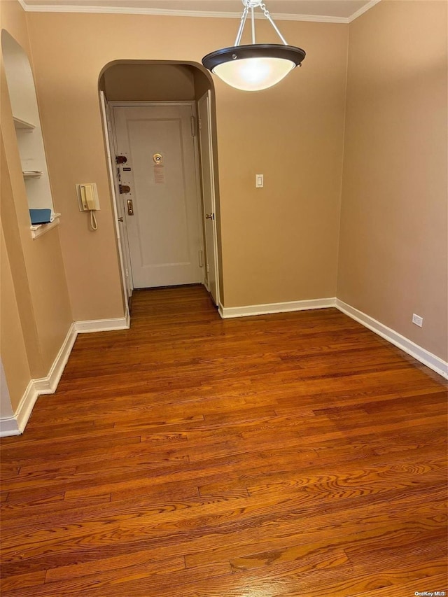 interior space featuring crown molding and wood-type flooring