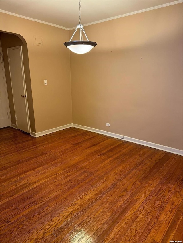 unfurnished room featuring dark hardwood / wood-style floors and crown molding