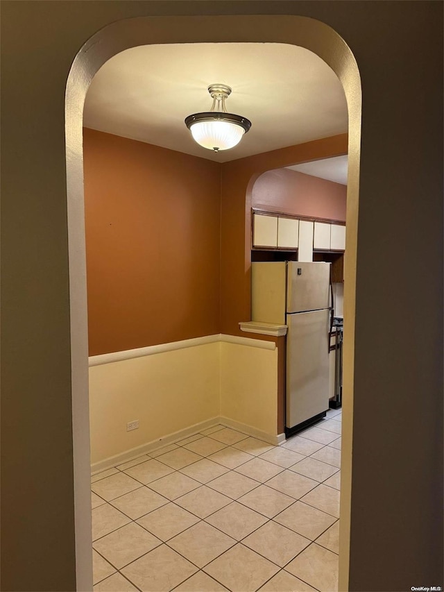 hallway featuring light tile patterned floors