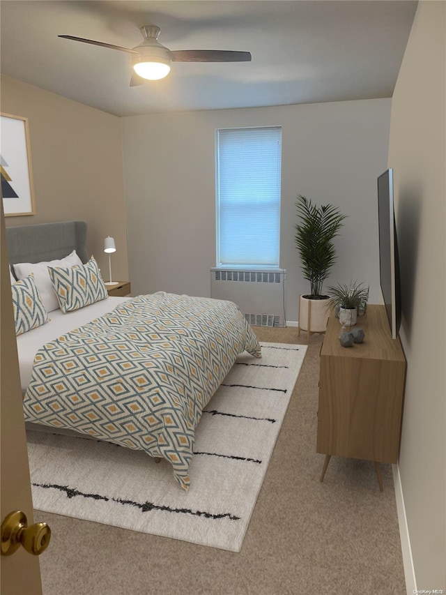 bedroom featuring carpet flooring, ceiling fan, and radiator heating unit