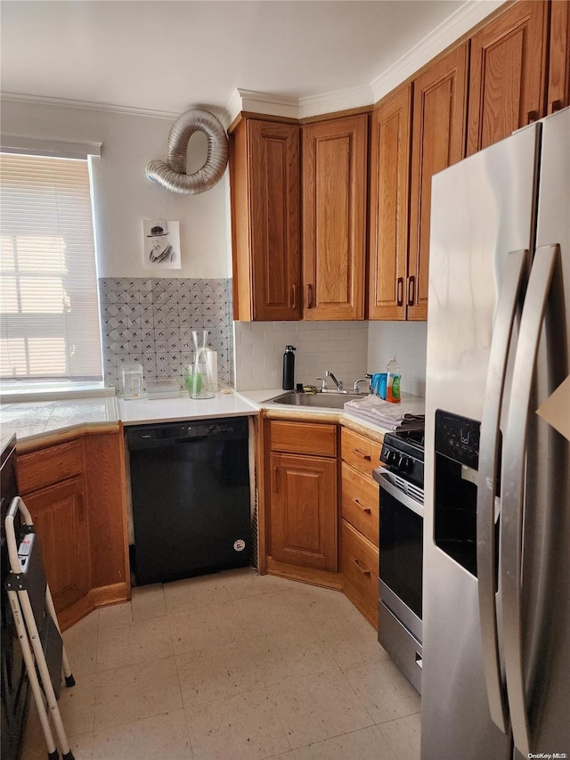 kitchen with appliances with stainless steel finishes, tasteful backsplash, crown molding, and sink